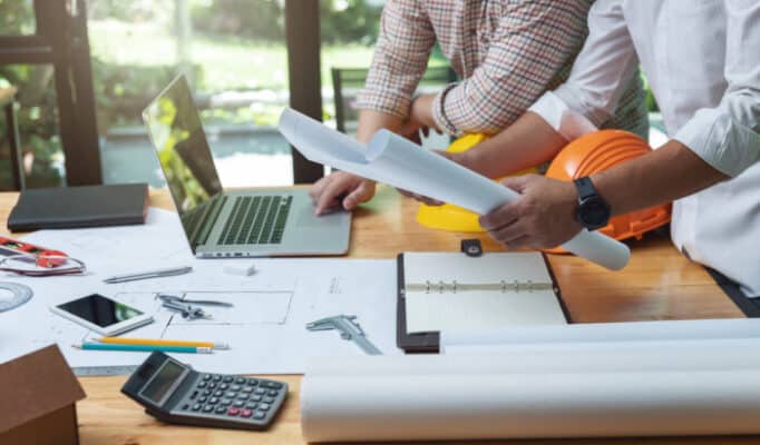 Engineer and Architect concept, Engineer Architects and real estate agent office team working with blueprints